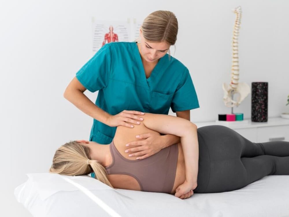 A physiotherapist assisting a patient during a home visit