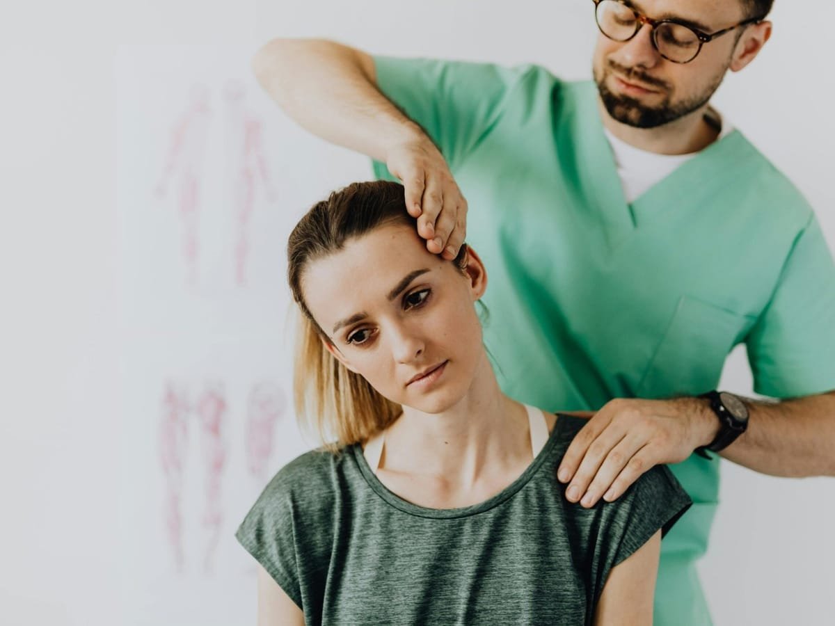 A physiotherapist checking in with a patient during a home visit